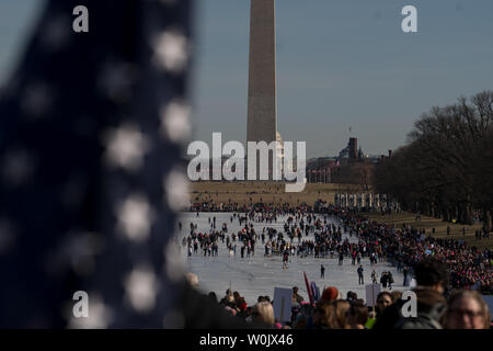 A large crowd fills up the reflecting pond in front of the Lincoln Memorial in Washington, D.C. on January 20, 2018. This is the one year anniversary of the Women's March where hundreds of thousands gathered in DC and all over the United States in support of women and to protest Donald Trump's election to President of the United States.     Photo by Ken Cedeno/UPI Stock Photo