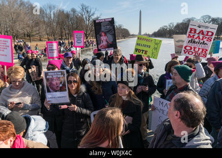 A large crowd gathered along the reflecting pool in front of the Lincoln Memorial for the Women's March in Washington, D.C. on January 20, 2018. This is the one year anniversary of the Women's March where hundreds of thousands gathered in DC and all over the United States in support of women and to protest Donald Trump's election to President of the United States.     Photo by Ken Cedeno/UPI Stock Photo