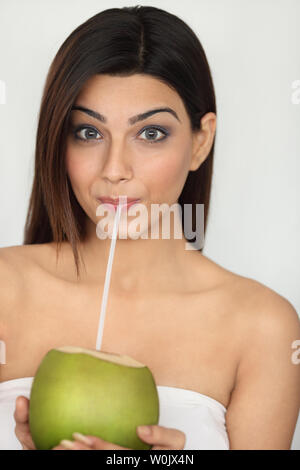 Portrait of an Indain woman drinking coconut water Stock Photo