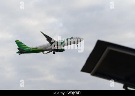 DENPASAR,BALI/INDONESIA-JUNE 08 2019: Citilink aeroplane is flying from Ngurah Rai International Airport Bali, when the sky is cloudy grey Stock Photo