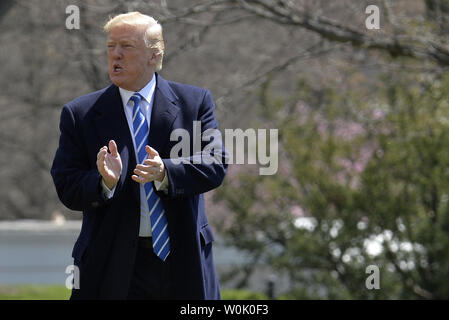 President Donald Trump gestures to guests gathered to watch his departure from the White House, Washington, DC, for a day trip to White Sulfur Springs, West Virginia, April 5, 2018. Trump will hold a round table discussion on the Tax Cuts and Jobs Act and hear from individuals who have benefited from the tax reform.      Photo by Mike Theiler/UPI Stock Photo