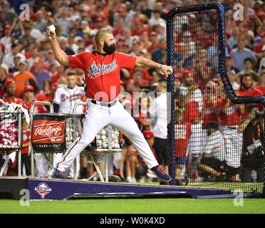 Washington Nationals' Bryce Harper (L) of the National League is awarded  the trophy by his father Ron Harper after winning the 2018 Home Run Derby  at Nationals Park in Washington, D.C. on