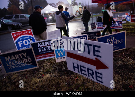 Volunteers wait outside the polling location at Loudon County High School in Leesbugh, Virginia on November 6, 2018. Americans head to the polls to vote in the midterm elections that will decide control the House of Representatives and the U.S. Senate. Photo by Kevin Dietsch/UPI Stock Photo
