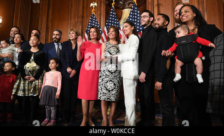 Newly elected Speaker of the House Nancy Pelosi swears in Rep. Alexandria Ocasio-Cortez, D-NY, at a mock event with family members at the U.S. Capitol in Washington, DC on January 3, 2019. Pelosi, 52nd Speaker of the House, became the first official to return to that position since Sam Rayburn in 1955.  Ocasio-Cortez is the youngest woman ever in Congress at age 29.     Photo by Pat Benic/UPI Stock Photo