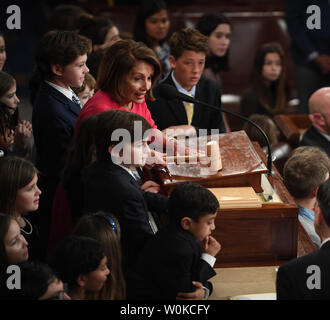 Congresswoman Nancy Pelosi (D-CA ), newly elected Speaker of the House of the 116th U.S. Congress, raps the gavel of office surrounded by children in the House Chamber on Capitol Hill in Washington, DC on January 3, 2019. Pelosi, 52nd Speaker of the House, became the first official to return to that position since Sam Rayburn in 1955.   Photo by Pat Benic/UPI Stock Photo