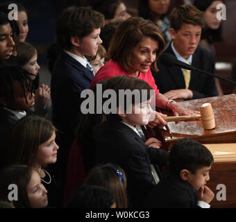 Congresswoman Nancy Pelosi (D-CA ), newly elected Speaker of the House of the 116th U.S. Congress, raps the gavel of office surrounded by children in the House Chamber on Capitol Hill in Washington, DC on January 3, 2019. Pelosi, 52nd Speaker of the House, became the first official to return to that position since Sam Rayburn in 1955.   Photo by Pat Benic/UPI Stock Photo