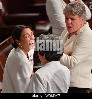 Alexandria Ocasio-Cortez (D-NY) (L) joins other congresswomen wearing white in honor of women's suffrage, as they arrive before President Donald Trump delivers his State of the Union address to a joint session of Congress in the House Chamber of the U.S. Capitol in Washington, DC on February 5, 2019.    Photo by  Kevin Dietsch/UPI Stock Photo