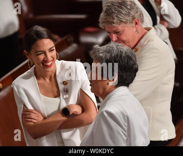 Alexandria Ocasio-Cortez (D-NY) (L) joins other congresswomen wearing white in honor of women's suffrage, as they arrive before President Donald Trump delivers his State of the Union address to a joint session of Congress in the House Chamber of the U.S. Capitol in Washington, DC on February 5, 2019.    Photo by  Kevin Dietsch/UPI Stock Photo