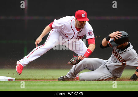 Washington Nationals second baseman Brian Dozier 9 tags out San Francisco Giants Steven Duggar as he attempted to steal second at Nationals Park in Washington D.C. on April 18 2019. Photo by