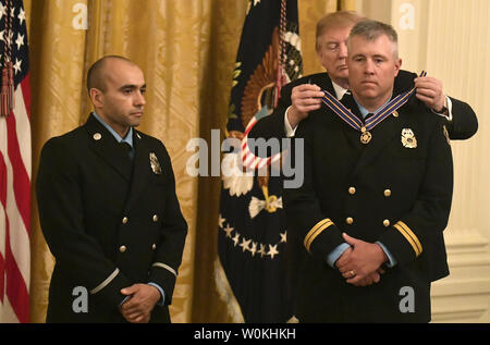 President Donald Trump presents Medal of Valors to Lenexa, Kansas Fire Capt. Dustin Moore (R) and Paramedic Andrew Freisner, in the East Room of the White House, Washington, DC, May 22, 2019. The firemen were honored for their rescuing a family in a burning apartment building in 2017.     Photo by Mike Theiler/UPI Stock Photo
