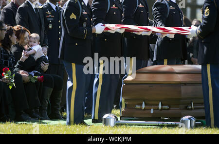Alexandra McClintock, the widow of U.S. Army Sgt. First Class Matthew Q. McClintock, holds their son Declan during his funeral at Arlington National Cemetery in Arlington, Virginia on March 7, 2015. SFC McClintock, a U.S. Army Special Forces soldier, was killed in action on Tuesday, January 5, 2016, in Afghanistan. Photo by Kevin Dietsch/UPI Stock Photo