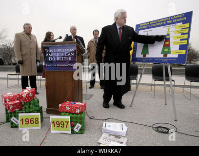 Sen. Edward Kennedy, D-Mass., right, speaks at a joint news conference with House Minority Whip Steny Hoyer, D-Md., and Rep. George Miller, D-Calif., outside of the U.S. Capitol building in Washington, December 14, 2005. Senate and Congress democrats hold a news conference to discuss 'the true meaning of Christmas: hope, generosity, and goodwill toward others.' The lawmakers will call on Congress to raise the national minimum wage before leaving for the year and they will release a report from the Center for Economic and Policy Research detailing the 'difficulty that families living on the min Stock Photo