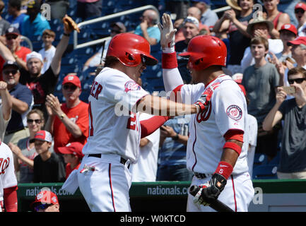 Washington Nationals pinch hitter Matt den Dekker (L) jubilates as he is congratulated by teammates after hitting a game-winning two-run home run in the bottom of the eighth inning against the Los Angeles Dodgers at Nationals Park in Washington, DC on July 18, 2015.   Nationals won the July 17th suspended game 5-3.  Photo by Pat Benic Stock Photo