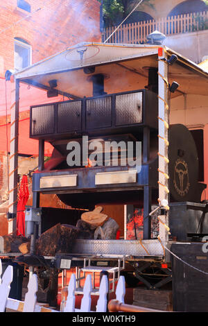 Giant meat smoker and BBQ next door to the Pythian Castle Lodge in historic Bisbee AZ Stock Photo