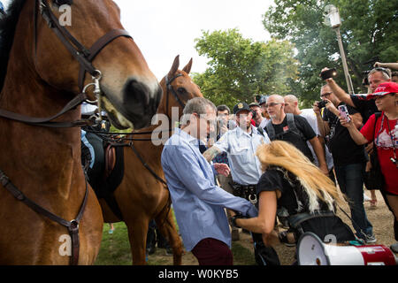 Counter-protesters pull away from US Park Police on horseback during the pro-trump 'Mother of All Rallies' event on the national mall in Washington, DC on September 16, 2017. The event was held to show support for President Trump and his agenda. Photo by Erin Schaff/UPI Stock Photo