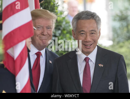 U.S. President Donald Trump greets the Singapore Prime Minister Lee Hsien Loong at the entrance to the West Wing of the White House in Washington, DC on October 23, 2017.   Lee is on a one-day visit to the White House.      Photo by Pat Benic/UPI Stock Photo