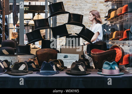 London, UK - June 22, 2019: Vintage hats on sale at stall inside Spitalfields Market, one of the finest surviving Victorian Market Halls in London wit Stock Photo
