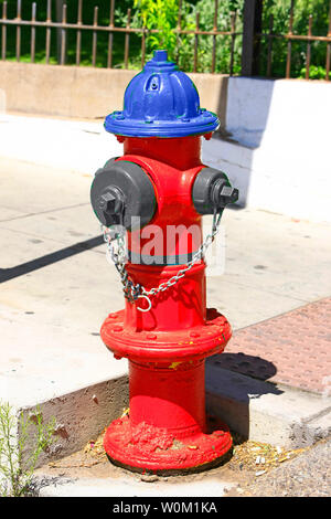 Red and Blue fire hydrant in downtown Bisbee AZ Stock Photo