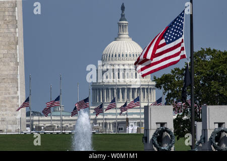 With the U.S. Capitol in the background the flags at the Washington Monument and World War II Memorial fly at half-staff in honor of Senator John McCain, in Washington on August 28, 2018. After pressure from congress and the public, President Donald Trump reversed his decision and ordered the flags at the White House and elsewhere to fly at half-staff until McCain is buried.    Photo by Pat Benic/UPI Stock Photo
