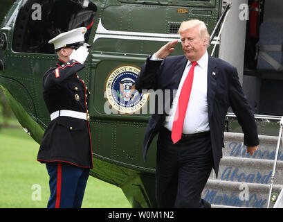 President Donald Trump salutes as he arrives via Marine One on the South Lawn of the White House in Washington, DC on September 27, 2018.   The president is returning from New York and the United Nations.   Photo by Pat Benic/UPI Stock Photo