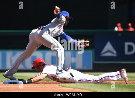 Washington Nationals' Trea Turner slides safely into third base as