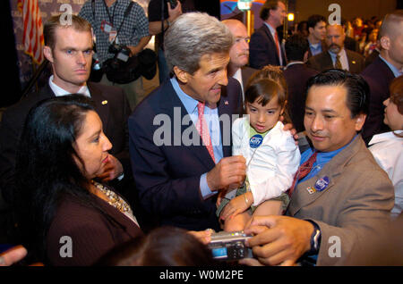 Senator and Presidential Candidate John F. Kerry takes a moment to have a picture made with 5-year-old Estrella Salazar and her father Steve Salazar from Dallas, Texas after speaking before the National Association of Latino Elected Officials (NALEO) at the Hyatt Regency Hotel on Capitol Hill on June 26, 2004 in Washington D.C.  (UPI Photo/Greg Whitesell) Stock Photo