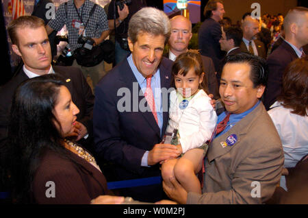 Senator and Presidential Candidate John F. Kerry takes a moment to have a picture made with 5-year-old Estrella Salazar and her father Steve Salazar from Dallas, Texas after speaking before the National Association of Latino Elected Officials (NALEO) at the Hyatt Regency Hotel on Capitol Hill on June 26, 2004 in Washington D.C.  (UPI Photo/Greg Whitesell) Stock Photo