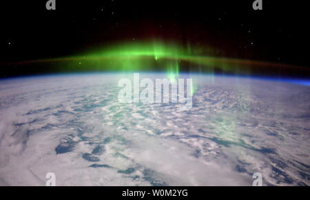 Expedition 46 flight engineer Tim Peake of the European Space Agency (ESA) shared this image of a glowing aurora taken on February 23, 2016 from the International Space Station. Peake wrote, 'The @Space Statoin just passed straight through a thick green fog of #aurora...eerie but beautiful. #Principia' The dancing lights of the aurora provide spectacular views on the ground, but also capture the imagination of scientists who study incoming energy and particles from the sun. Aurora are one effect of such energetic particles, which can speed out from the sun both in a steady stream called the so Stock Photo