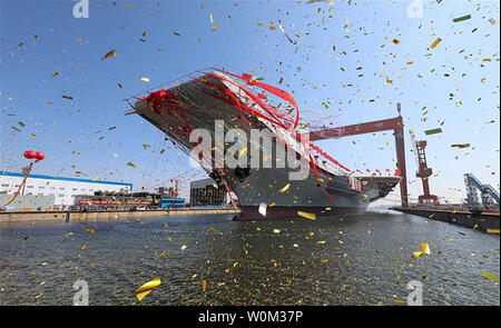 China's second aircraft carrier is transferred from dry dock into the water at a launch ceremony in Dalian shipyard of the China Shipbuilding Industry Corp. in Dalian, northeast China's Liaoning Province, on April 26, 2017. The new carrier, the first domestically-built one, came after the Liaoning, a refitted former Soviet Union-made carrier that was put into commission in the Navy of the Chinese People's Liberation Army in 2012. Photo via Xinhua/UPI Stock Photo