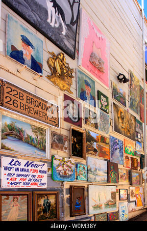 Amateur artworks placed outside on a wall of a building in an alley leading to Broadway from Brewery Ave in Bisbee, AZ Stock Photo