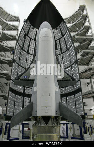 The X-37B Orbital Test Vehicle (OTV), the Air Force's unmanned, reusable space plane, waits in the encapsulation cell of the Evolved Expendable Launch vehicle on April 5, 2010, at the Astrotech facility in Titusville, Fla. Half of the Atlas V five-meter fairing is visible in the background. Photo by Boeing/U.S. Air Force/UPI Stock Photo