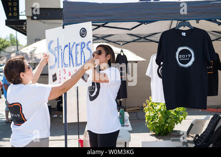 Lili Bornio, right, and her mom, set up to sell eclipse shirts and stickers, that she designed, to raise money for medical school, in Madras, Oregon, on August 19, 2017. Thousands of visitors are expected in Madras to view the total solar eclipse. The eclipse will be sweeping across a narrow portion of the contiguous United States from Lincoln Beach, Oregon to Charleston, South Carolina on August 21. A partial solar eclipse will be visible across the entire North American continent along with parts of South America, Africa, and Europe. NASA Photo by Aubrey Gemignani/UPI Stock Photo