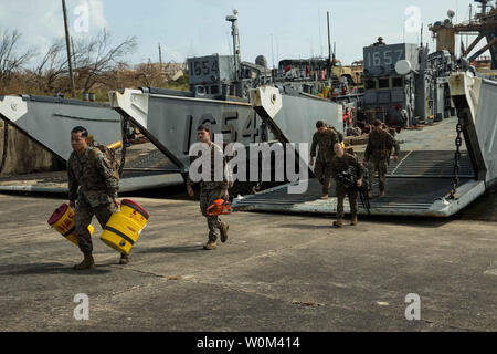 U.S. Marines with Battalion Landing Team 2nd Battalion, 6th Marine Regiment, 26th Marine Expeditionary Unit (MEU), exit U.S. Navy Landing Craft, Utility 1657 to assist in relief efforts for victims of Hurricane Maria in Ceiba, Puerto Rico, on September 24, 2017. The 26th MEU is supporting the Federal Emergency Management Agency, the lead federal agency, and local authorities in Puerto Rico and the U.S. Virgin Islands with the combined goal of protecting the lives and safety of those in affected areas. Photo by Lance Cpl. Tojyea G. Matally/U.S. Marine Corps/UPI
