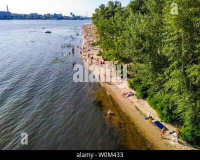 Kyiv, Ukraine - June 16, 2019: People rest on the banks of the Dnipro River in recreation area of Trukhaniv Island, Kiev, Ukraine Stock Photo