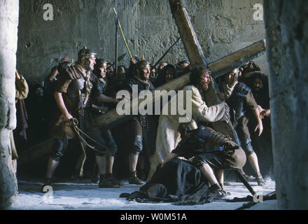 Jesus (Jim Caviezel) carries the Cross in a scene from The Passion of The Christ, Mel Gibson's controversial new film about the last twelve hours of Christ's life. Critics charge the film is anti-Semitic and graphically violent.    (UPI Photo/Philippe Antonello/Newmarket Films) Stock Photo