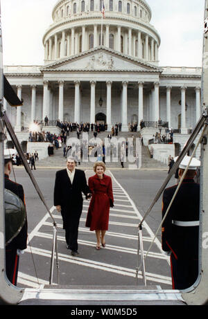 Former President Ronald Reagan and his wife, Nancy, are seen here January 20, 1989 walking toward Nighthawk I, the helicopter which will take them to Andrews Air Force Base for their flight back home to California, following the inauguration of George H.W.Bush. (UPI/File) Stock Photo