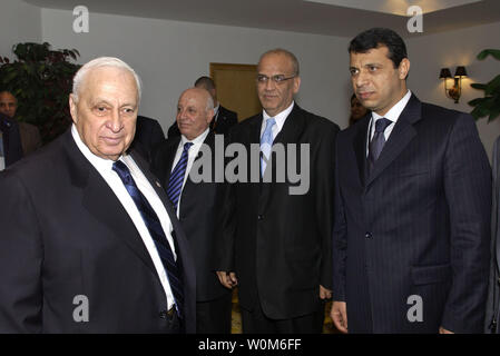 Israeli Prime Minister Ariel Sharon, left, passes Palestinian delegates Mohamed Dahalan, right, Saeb Erekat, center, and Palestinian Prime Minister Ahmed Qurei as he enters his bilateral meeting with Palestinian President Mahmoud Abbas for their bilateral meeting at the peace summit February 8, 2005 at the Egyptian Red Sea resort of Sharm el-Sheikh. (UPI Photo/Avi Ohayon) Stock Photo