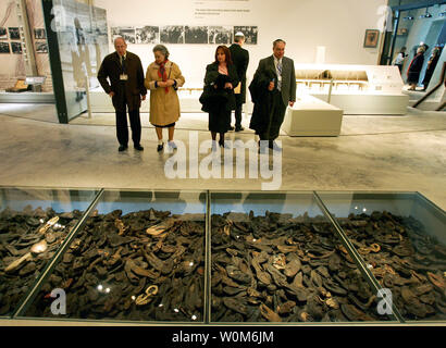 Visitors look at shoes of Jews killed by the Nazis, at the Yad Vashem Holocaust Memorial's new museum in Jerusalem March 15, 2005. World leaders inaugurated a museum at Israel's Holocaust memorial on Tuesday in a show of international determination to keep alive the memory of the six million Jews killed by the Nazis and prevent future genocide.  (UPI Photo/Goran Tomasevic) Stock Photo