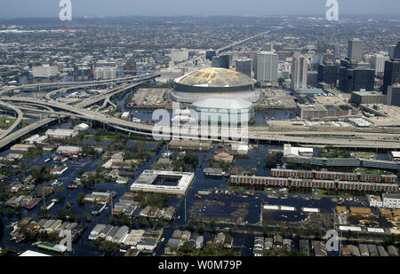 Aerial view from a U.S. Navy helicopter, assigned to Helicopter Sea Combat Squadron Two Eight (HSC-28), shows the rising flood waters threatening the entire downtown New Orleans city center, including the famed Superdome on August 31, 2005.  Interstate 10 runs to the top of the photograph heading east and Route 90 runs horizontal to connect to New Orleans' West Bank across the Mississippi River.  The tall office and hotel buildings are on Canal Street in the main business district, which runs into the famed French Quarter that is directly behind the tall buildings to the right of the photograp Stock Photo