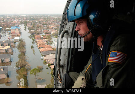 Coast Guard Petty Officer 2nd Class Shawn Beaty, 29, of Long Island, N.Y., looks for survivors in the wake of Hurricane Katrina in New Orleans on August 30, 2005.  Beaty is a member of an HH-60 Jayhawk helicopter rescue crew sent from Clearwater, Fla., to assist in search and rescue efforts. (UPI Photo/NyxoLyno Cangemi/USCG) Stock Photo