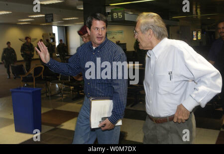 Louisiana Senator David Vitter discusses Hurricane Katrina relief efforts with Secretary of Defense Donald H. Rumsfeld as they walk through the New Orleans, LA. airport  on Sept, 4, 2005.     (UPI Photo/ Kevin J. Gruenwald, USAF) Stock Photo