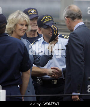 Prince Charles, right, shakes hands on deck with members of the U.S. Coast Guard patrol boat Tern as his wife, Camilla, Duchess of Cornwall holds a hat given to her after arriving at the Ferry Building in San Francisco, November 7, 2005. The royal couple posed for pictures with the crew before touring the Ferry Building.    (UPI Photo/Eric Risberg, Pool) Stock Photo