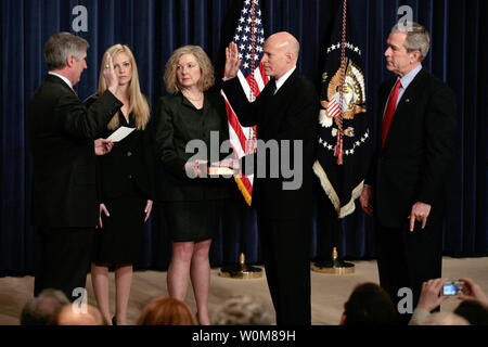 President George W. Bushstands at right as Andrew Card, White House Chief of Staff, left, swears in Edward 'Eddie' Lazear  as Chairman of the Council of Economic Advisors at the EEOB in Washington on March 6, 2006. Lazear's wife Vicki holds bible, and daughter Julie stands with Lazear.   (UPI Photo/Ken Cedeno) Stock Photo