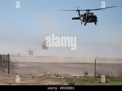 Army UH-60 Black Hawk helicopters lift off from Forward Operating Base Remagen, Iraq, for Operation Swarmer on March 16, 2006.  Soldiers from the Iraqi Army's 1st Brigade, 4th Division and the U.S. Army's 101st Airborne Division's 3rd Brigade Combat Team are taking part in the combined air assault operation to clear the area northeast of Samarra of suspected insurgents.  (UPI Photo/Antony Joseph/U.S. Army) Stock Photo
