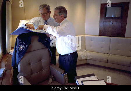 President George W. Bush confers with Chief of Staff Andrew Card aboard Air Force One en route to El Paso in this March 2002 file photo.  Tuesday, March 28, 2006, the President announced the resignation of Secretary Card effective in April.  (UPI Photo/Eric Draper/White House) Stock Photo