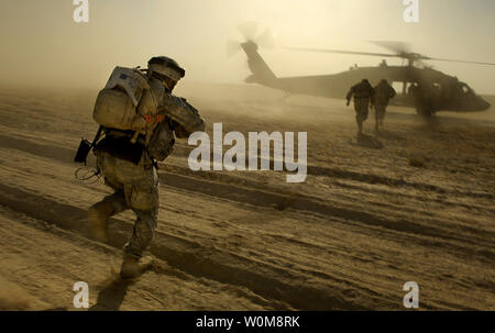 A UH-60 Blackhawk Helicopter Lands To Extract Members Of The U.S. Army ...