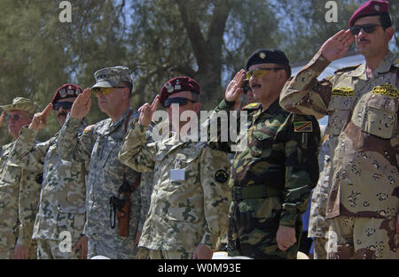 The Multinational Division-Central South (MND-CS) Change of Command official party stands and salutes as soldiers from various nations pass the review stand during the parade of nations at the Multinational Division Central South Change of Command Ceremony at Camp Echo, Iraq, on Tuesday, July 18, 2006. The parade consisted of nations that make up the MND-CS command. U.S. Army Lt. Gen Peter Chiarelli Multinational Corps - Iraq Commander officiated the ceremony where Polish Army Maj. Gen. Edward Gruszka relinquished command to Polish Army Maj. Gen. Bronislaw Kwiatkowski. (UPI Photo/Adrian Cadiz/ Stock Photo