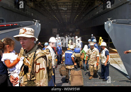 U.S. Sailors aboard the amphibious transport dock USS Nashville (LPD 13), assist arriving civilian personnel from one of the ship's landing craft utility (LCU) vessels on July 21, 2006. USS Nashville is on a regularly scheduled deployment, and is assisting the U.S. Central Command and 24th Marine Expeditionary Unit (MEU) with the departure of U.S. citizens from Lebanon, at the request of the U.S. Ambassador to Lebanon and at the direction of the Secretary of Defense. (UPI Photo/US NAVY) Stock Photo
