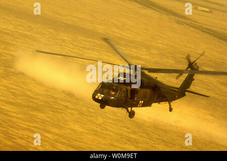 U.S. Army crew members assigned to the 542nd Medical Company (Air Ambulance) prepare to land in a UH-60A Black Hawk helicopter, during a mission near Tall Afar, Iraq on July 30, 2006.  (UPI Photo/Jacob N. Bailey/US Army) Stock Photo