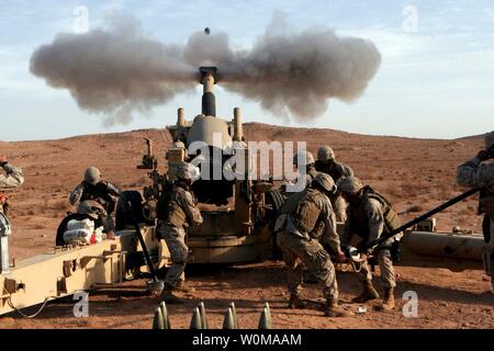 U.S. Marines from 3rd Battalion, 12th Marine Regiment fire a 120mm artillery round from a M198 Howitzer in western Al Anbar Province, Iraq on December 21, 2006. (UPI Photo/ Michael Q. Retana/U.S. Marines) Stock Photo